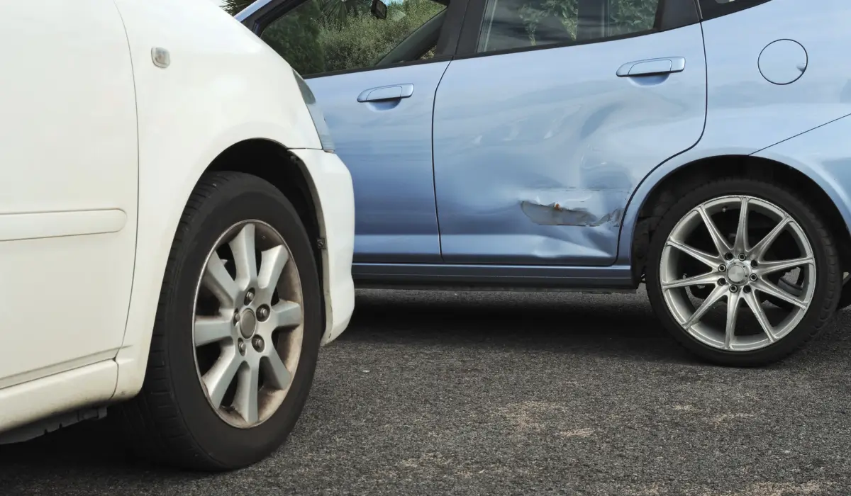 Police at car accident scene assisting injured drivers while an insurance company later disputes the seriousness of reported injuries.