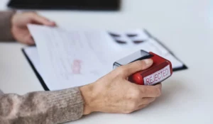 Person holding application stamped rejected, symbolizing how Criminal Records block housing and job opportunities in Chicago.